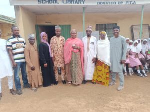 2006 Alumni with the Junior Principal of Okelele Secondary School at the school premises. 