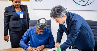 Photo of the DG NITDA, Kashifu Inuwa CCIE (middle), signing the agreement document to commence the project on the establishment of the Startup Hub in Abuja