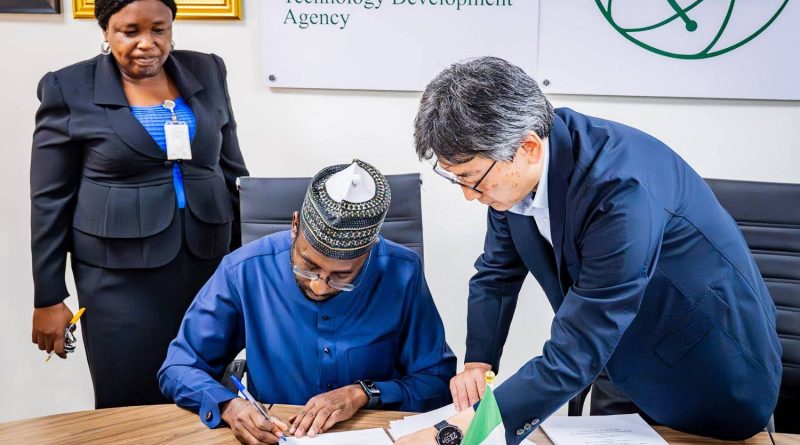 Photo of the DG NITDA, Kashifu Inuwa CCIE (middle), signing the agreement document to commence the project on the establishment of the Startup Hub in Abuja